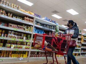 Woman shopping inside a Trader Joe's retail store, Kirkland, Washington state, February 2022